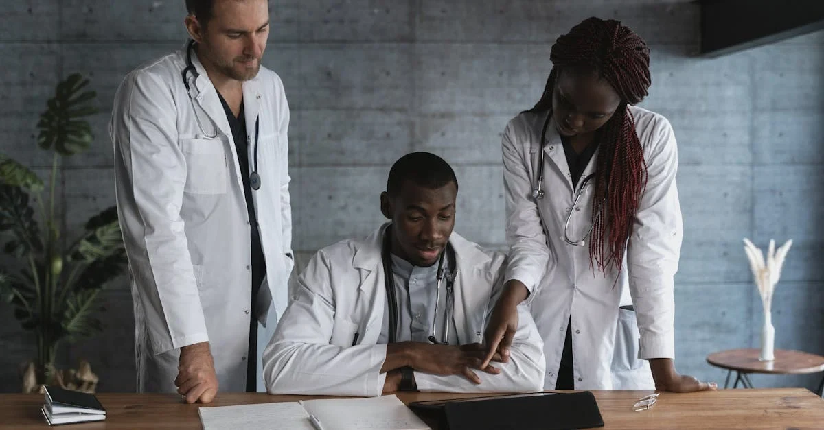 Three healthcare professionals in white coats reviewing RCM calculator results on laptop at wooden desk.
