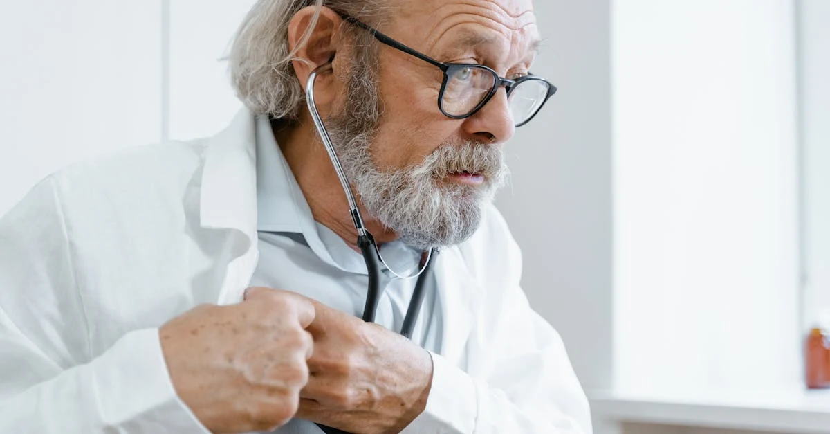 Doctor with stethoscope and glasses examining patient while ambient AI scribe technology captures medical notes.