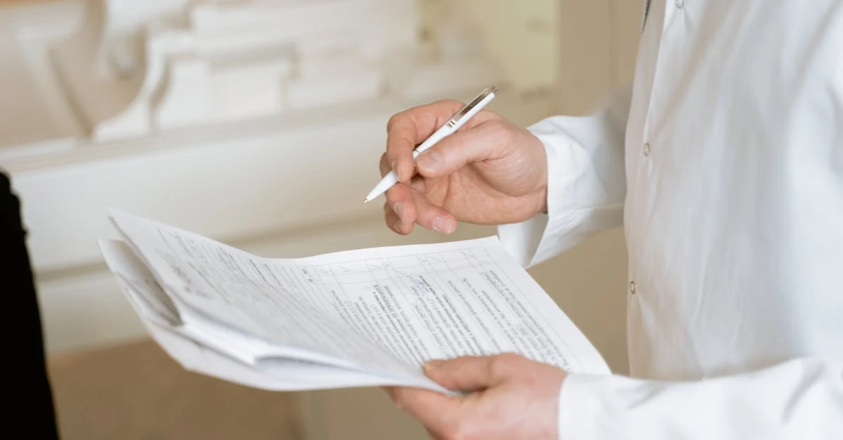 Healthcare professional reviewing patient documentation for inpatient vs outpatient coding compliance.