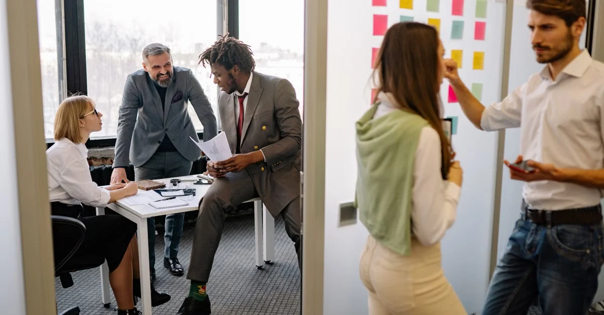 Business professionals collaborating on general surgery coding strategy with sticky notes and documents in modern office.