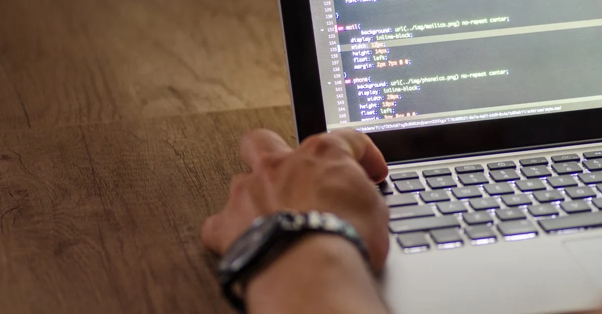 Developer reviewing medical coding risk adjustment code on laptop screen with programming syntax displayed.