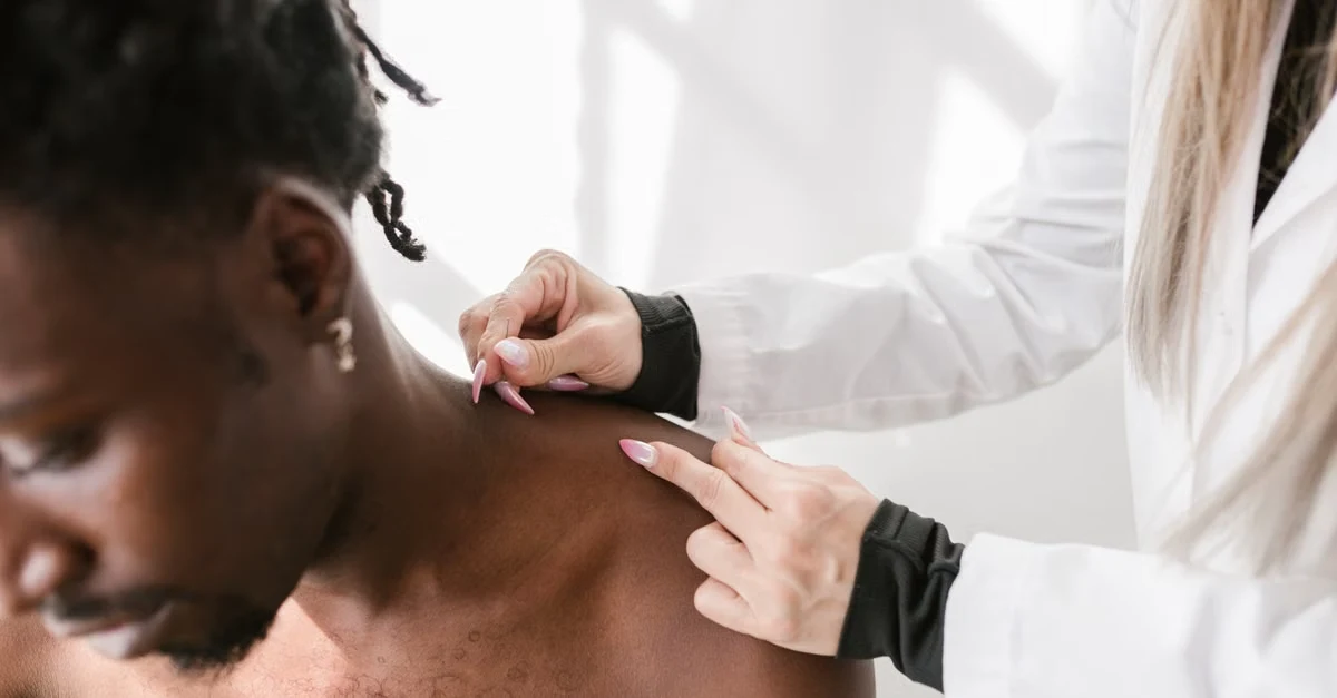 Healthcare provider examining patient's skin condition for dermatology documentation and ai scribe assessment.